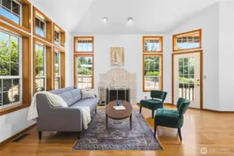 Living room with wood burning fireplace opens off of the front entry foyer.