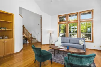 Living room is bright with windows on all sides.