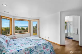 Primary bedroom upstairs to take in the the best water views from your private deck.