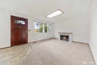 Good size living room with wood burning fireplace.