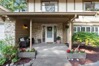 Features a large, covered porch at entrance.