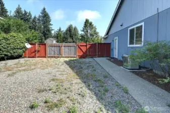 RV parking and sidewalk that leads to back patio