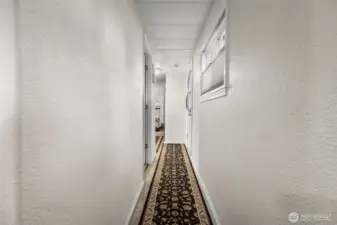 Down the hall to the 2 bedrooms, bathroom, and 2 additional exterior access options.