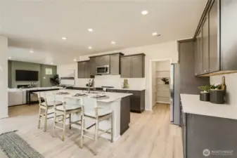 Kitchen and extra large pantry.  Photos are representation as the home is under construction.