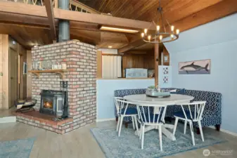 Entry hall to left, cozy fireplace for cooler days, delightful dining alcove with kitchen behind.