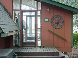 Entry porch with storage room on side.