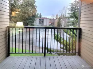 Deck off of livingroom looks at tennis court