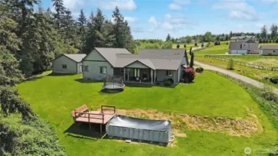 Set on several beautifully landscaped acres, this property offers a stunning blend of manicured grounds and natural beauty.  virtually enhanced grass.