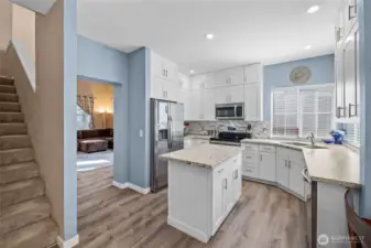 Easy care laminate flooring and white shaker cabinets!