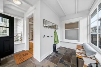 Inviting sun room creates an excellent area for mornings and creates a clean open area before heading indoors