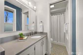 Primary ensuite 3/4 bathroom has 2 windows that face the bay view
