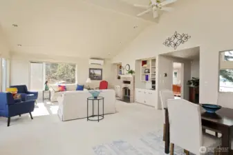 Living and dining area with a cozy fireplace.
