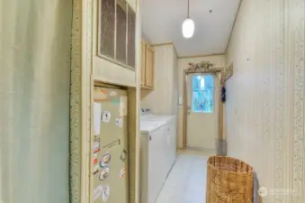 Laundry room with entrance to expansive covered carport.
