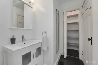 Large closet located behind the bathroom door for additional storage