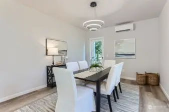 Spacious dining room with HP-mini split and modern lighting.