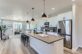 Custom built quartz counters, stainless steel appliances, and convection cooking in your gorgeous kitchen with expansive eat up island.