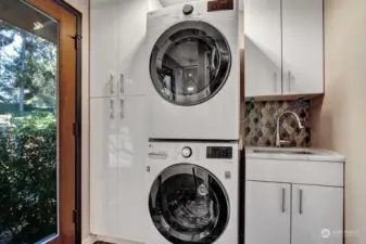 Laundry area with utility sink and SMART washer and dryer.