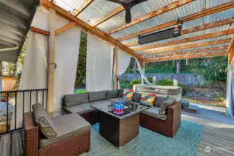 Massive covered patio with Jacuzzi J-315 hut tub has an installed heating element and a fan. Custom designed privacy curtains. Patio furniture conveys.