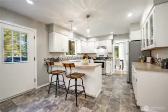 Kitchen with breakfast bar.  Door leads to deck