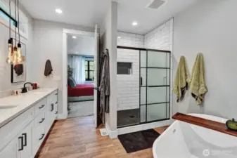 Ample vanity space, and thoughtfully designed lighting that creates a serene ambiance. Beautifully tiled shower with glass enclosure adds a touch of contemporary elegance.