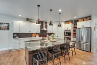 The kitchen is a chef's dream, meticulously designed with top-of-the-line appliances and ample space to create culinary masterpieces.