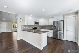 The kitchen has been refreshed with white cabinetry and Quartz surfaces.
