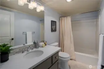 Full bath with tub/shower combo.