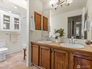 Full bathroom with double vanity and tub/shower.