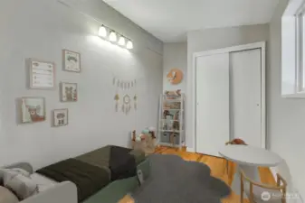 This smallish bedroom is virtually staged and is off the dining room