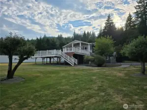 Viewing this beautiful home and yard from the campground like woods. You are sure to get to know the local deer as they bring their little ones around every year to the 5 apple trees in the yard.