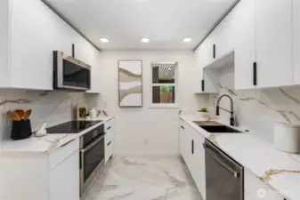 Quartz countertops with full-height backsplash and stainless appliances deliver both style and performance in this brand new kitchen.