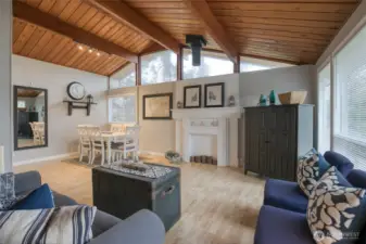 Welcome home to a spacious but cozy living room with vaulted tongue and groove pine wood ceilings.