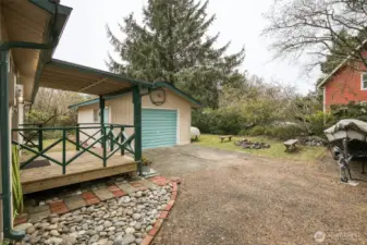 Fun entertaining spot with large firepit area and natural fence of mature greenery.