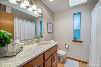 The hall bathroom has updated vanity and quartz countertops.