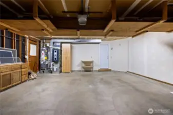 Lots of storage!  Here is your new furnace and hot water heater and a door to the side yard for easy access.