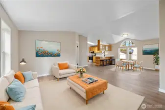 Virtually staged photo looking toward the kitchen from the front door