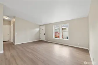Looking toward the front door and hallway toward the secondary bedrooms and hall bathroom