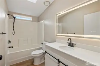 Hall bathroom with lit LED mirror