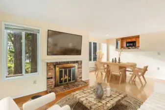 Virtually staged dining area with a pass through to the kitchen