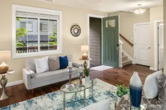 The entry opens to a great room with hardwood floors that flow throughout the main living areas.