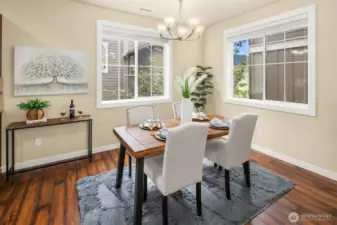 Light-filled dining room area accented with windows.