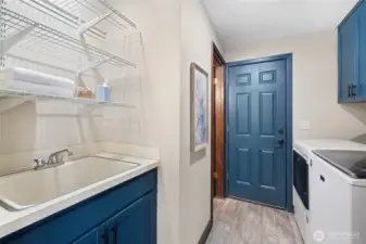 Utility room connects the dining area, half bath, and garage.  Washer and dryer included.