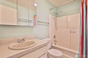 Full bath located off the hallway near bedrooms. The floor here is vinyl flooring.