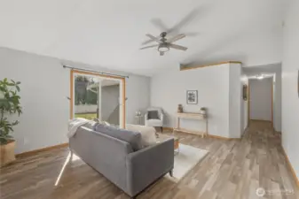 Down the hallway (on the right side of this photo), you'll find a full bathroom, a laundry room, and 3 bedrooms.