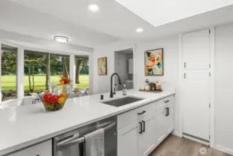 Bright and beautiful kitchen with quartz countertops looks out at the golf course