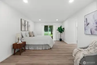 Spacious primary bedroom with sliding doors to patio