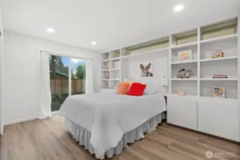 Bedroom 2 with built-ins and sliding door to a private patio