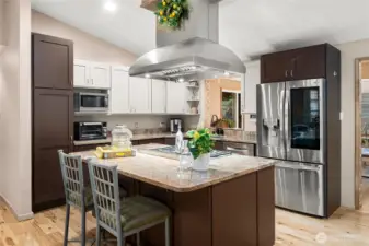 Fully remodeled, conversational kitchen with a cooktop island.