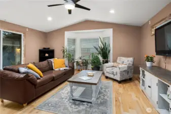 Large bay windows flood the home with natural light, perfect for indoor plants.