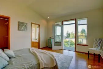 Primary Bedroom with vaulted ceilings, walk-in closet and private deck!
